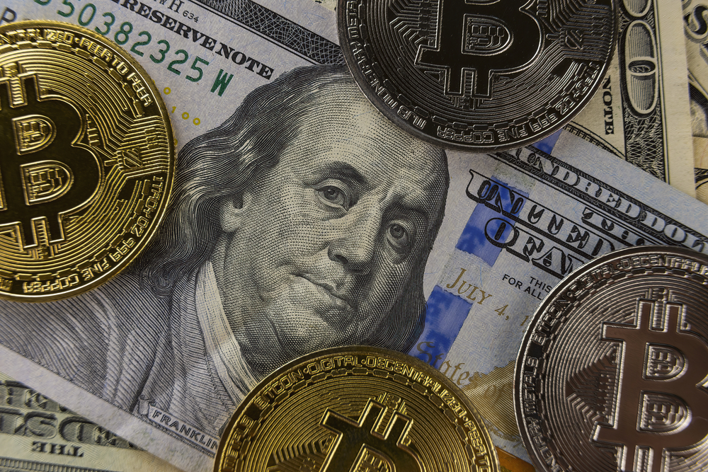 bitcoin coins lie on dollars close-up